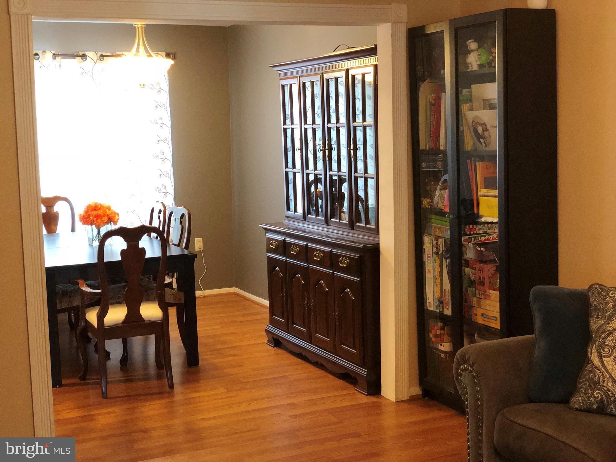 8989 Centerway Road Gaithersburg, MD 20879 - Photo 7 of 26 a living room with furniture and a wooden floor