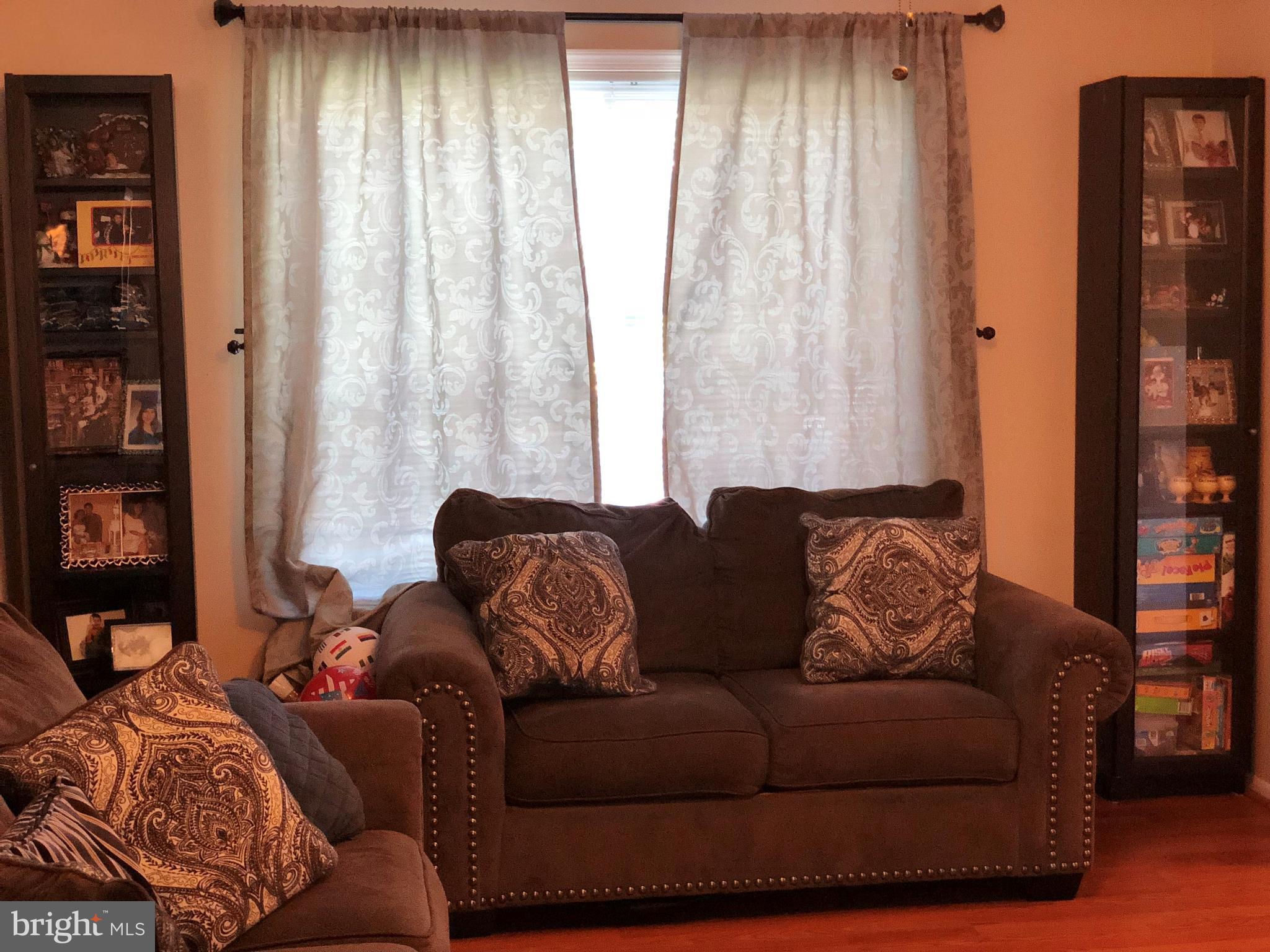 8989 Centerway Road Gaithersburg, MD 20879 - Photo 8 of 26 a living room with furniture and a window