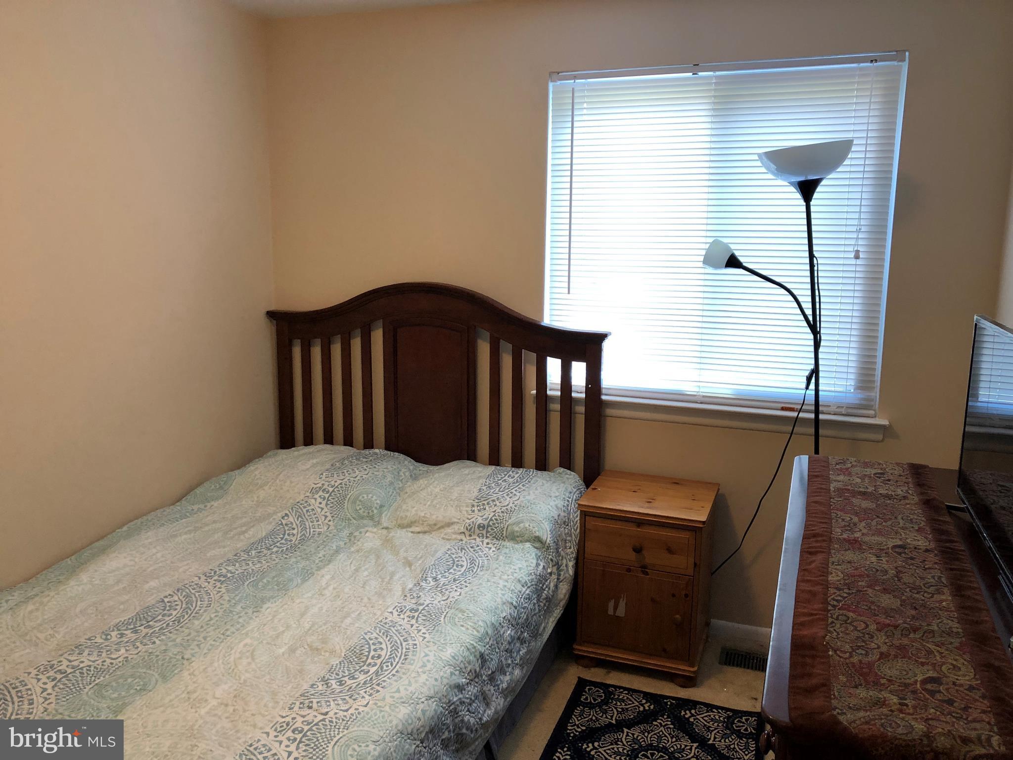 8989 Centerway Road Gaithersburg, MD 20879 - Photo 9 of 26 a bedroom with a bed and with a mirror on dresser