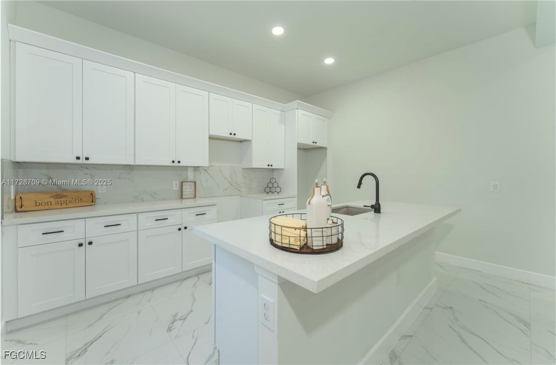 729 Giorgio Avenue Lehigh Acres, FL 33974 - Photo 1 of 21 a kitchen with sink a stove and cabinets