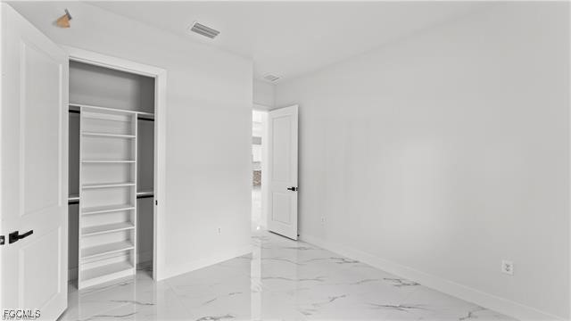 729 Giorgio Avenue Lehigh Acres, FL 33974 - Photo 12 of 21 an empty room with closet and mirror