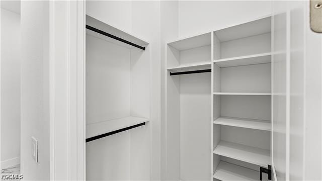729 Giorgio Avenue Lehigh Acres, FL 33974 - Photo 13 of 21 a view of walk in closet with empty racks