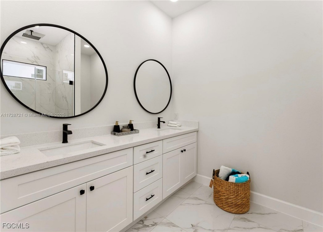 729 Giorgio Avenue Lehigh Acres, FL 33974 - Photo 18 of 21 a bathroom with a double vanity sink and a mirror