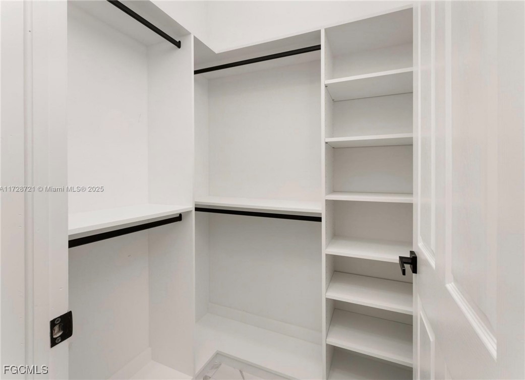 729 Giorgio Avenue Lehigh Acres, FL 33974 - Photo 19 of 21 a view of an empty walk in closet