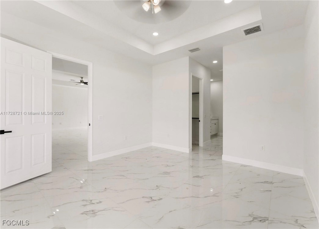 729 Giorgio Avenue Lehigh Acres, FL 33974 - Photo 20 of 21 an empty room with fan and entrance