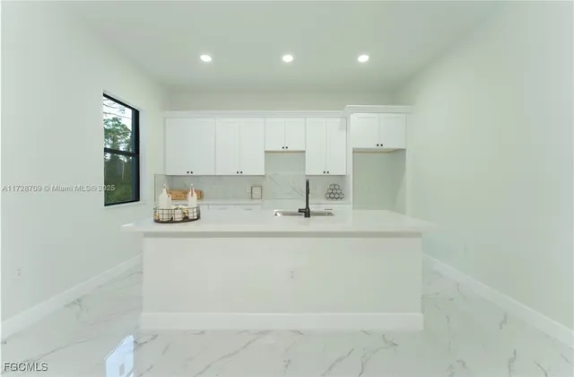a kitchen with a sink cabinets and wooden floor