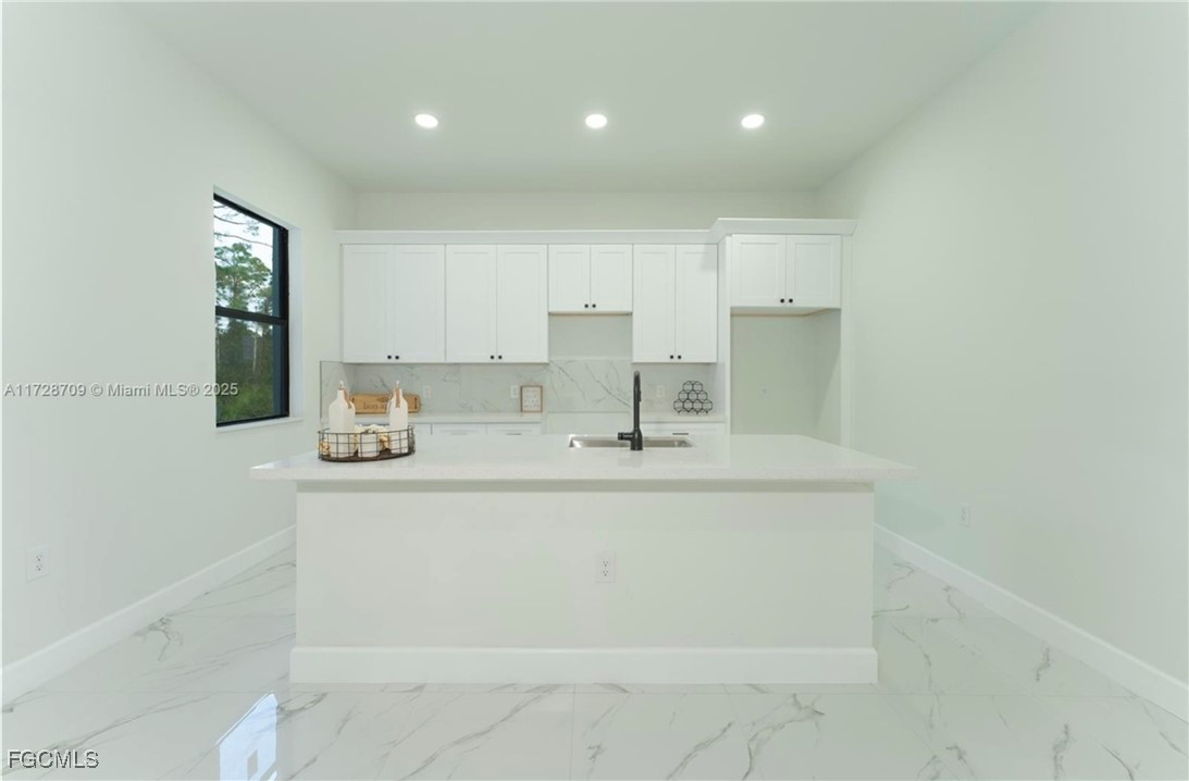 729 Giorgio Avenue Lehigh Acres, FL 33974 - Photo 6 of 21 a kitchen with a sink cabinets and wooden floor
