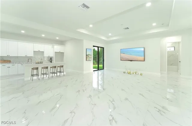 a view of a hallway with two chair and a fireplace