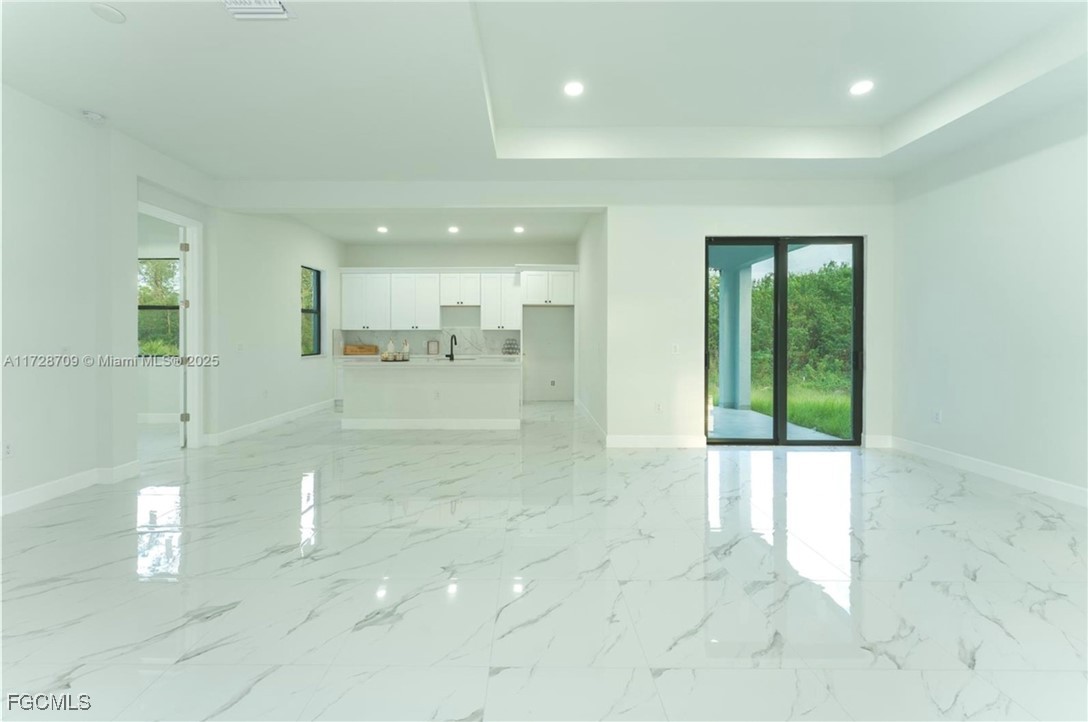 729 Giorgio Avenue Lehigh Acres, FL 33974 - Photo 10 of 21 a view of a hallway with two chair and a fireplace