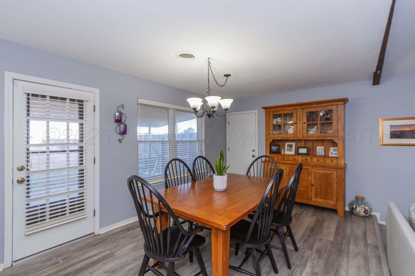 7612 Farrell Drive Amarillo, TX 79121 - Photo 11 of 27 a view of a dining room with furniture window and wooden floor