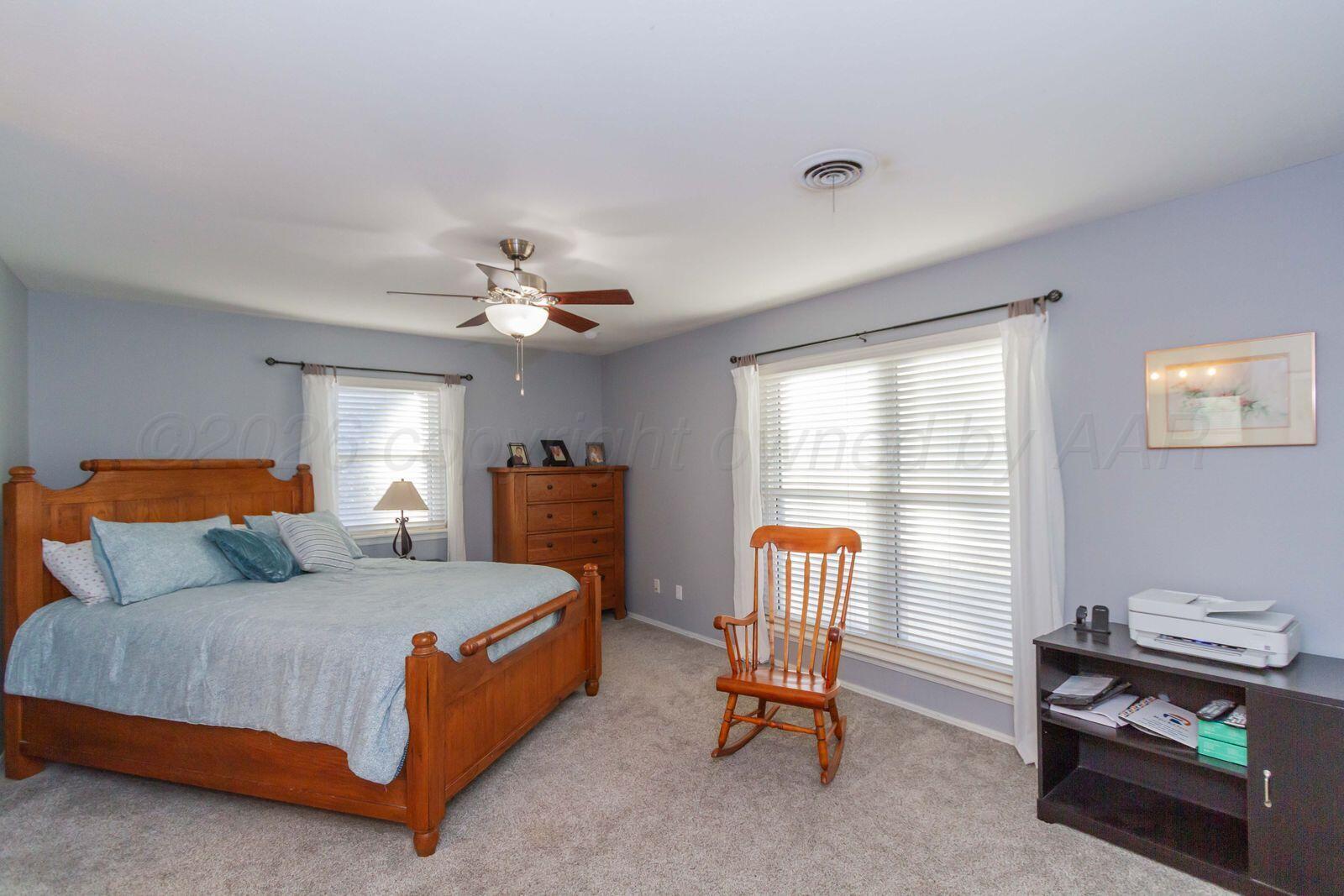 7612 Farrell Drive Amarillo, TX 79121 - Photo 14 of 27 a bedroom with a bed chair and window