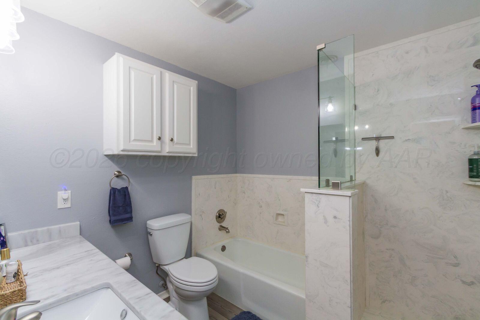 7612 Farrell Drive Amarillo, TX 79121 - Photo 16 of 27 a bathroom with a toilet and a bathtub