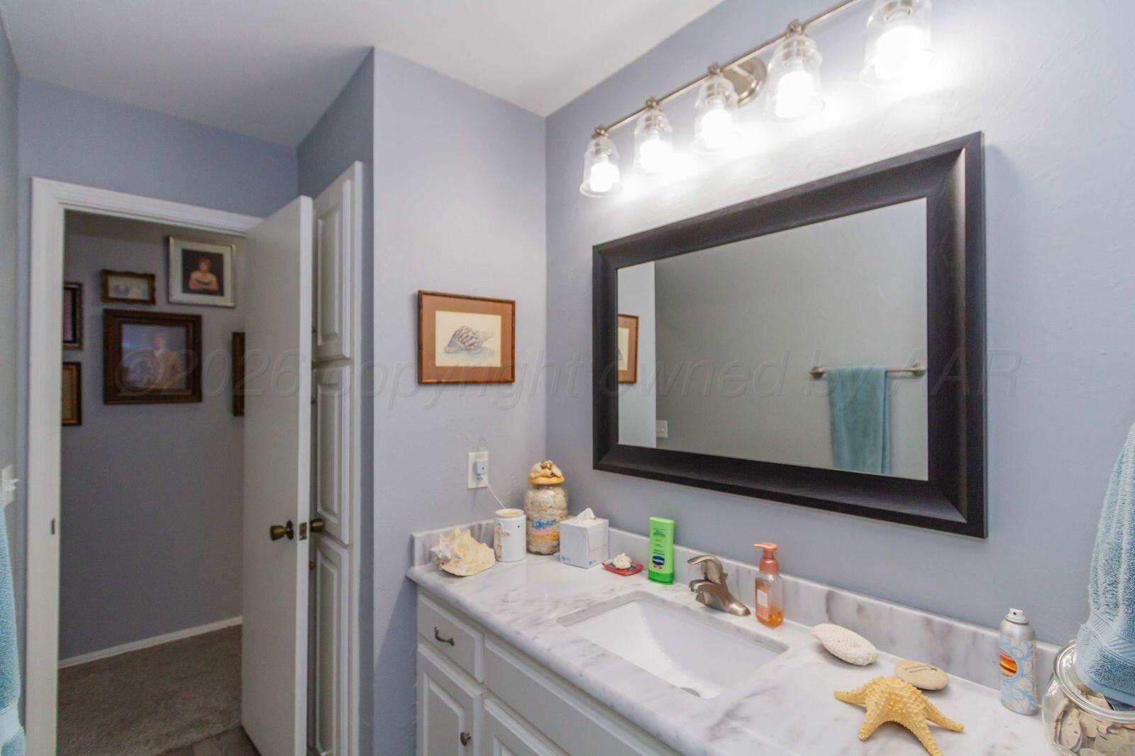 7612 Farrell Drive Amarillo, TX 79121 - Photo 22 of 27 a bathroom with mirror sink and vanity