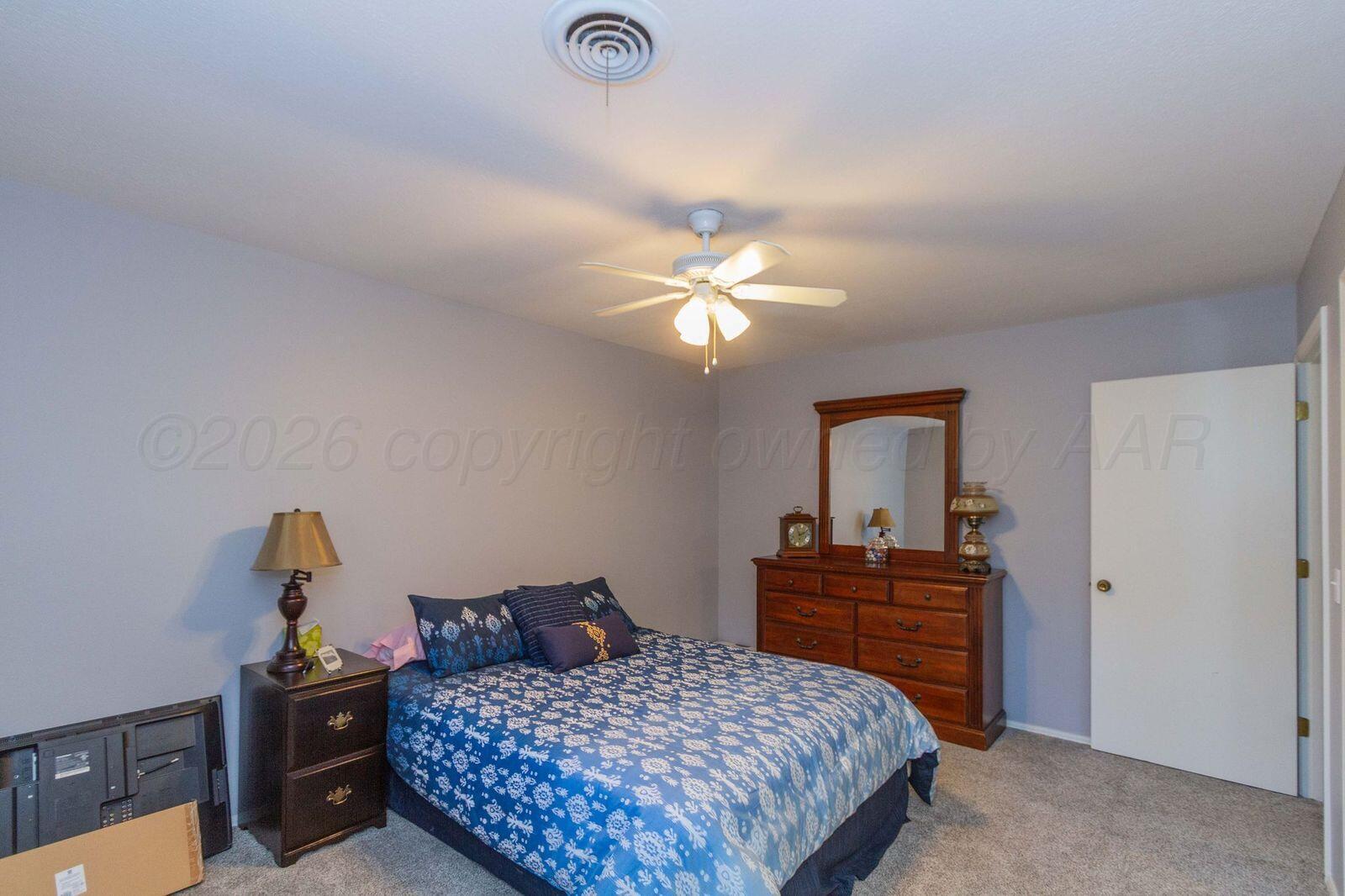 7612 Farrell Drive Amarillo, TX 79121 - Photo 24 of 27 a bedroom with a bed and a dresser