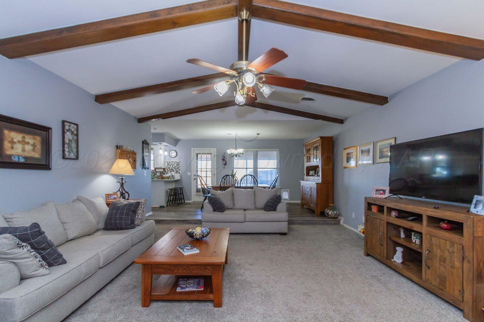 7612 Farrell Drive Amarillo, TX 79121 - Photo 6 of 27 a living room with furniture and a flat screen tv