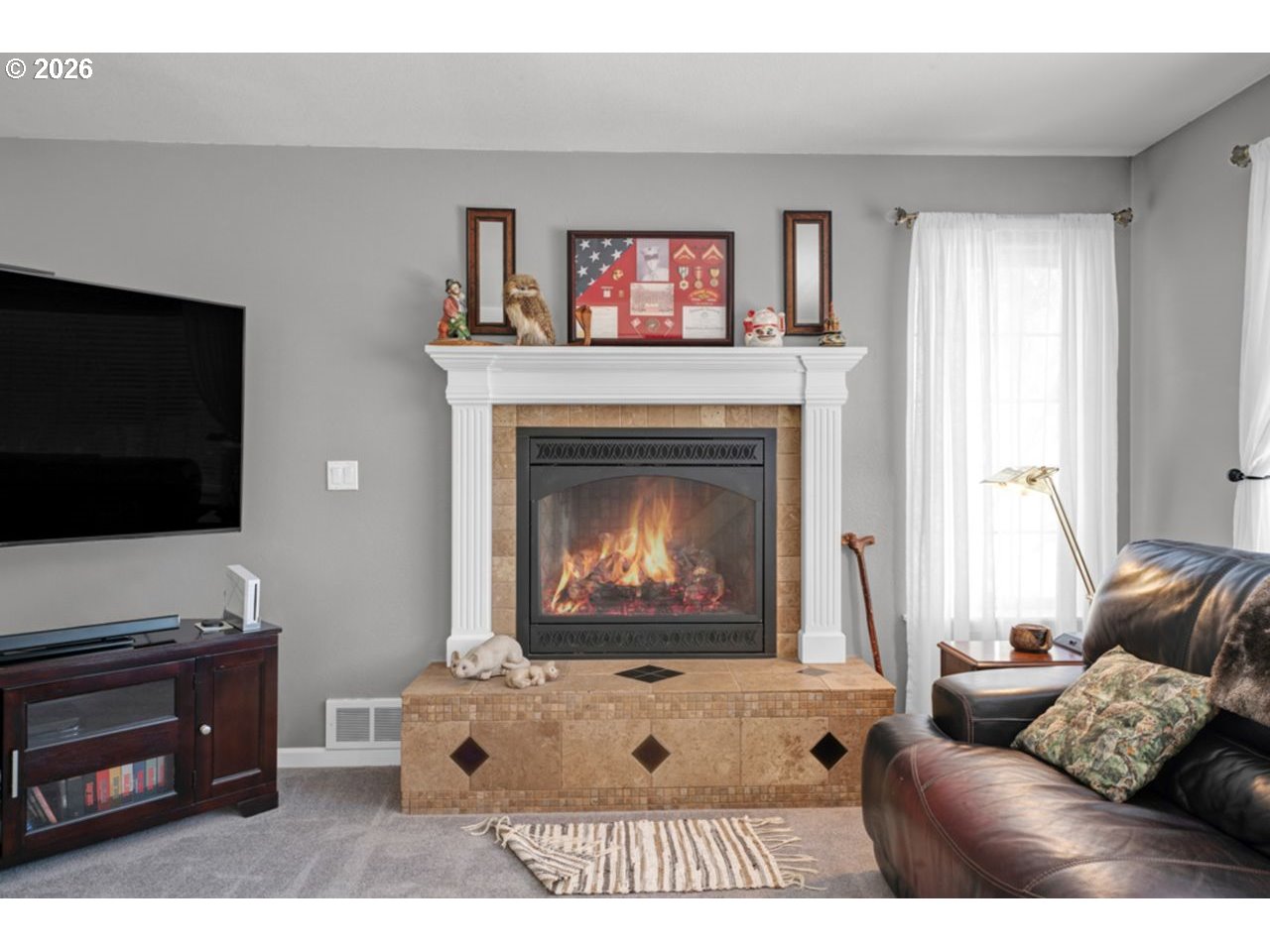7 Onadoone Court Florence, OR 97439 - Photo 15 of 44 a living room with furniture a flat screen tv and a fireplace