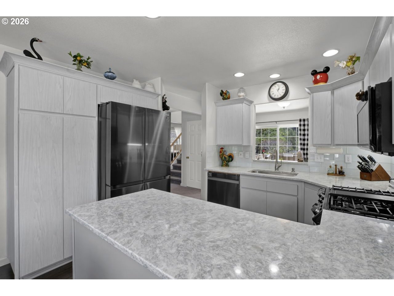 7 Onadoone Court Florence, OR 97439 - Photo 7 of 44 a kitchen with stainless steel appliances kitchen island granite countertop a refrigerator and a sink