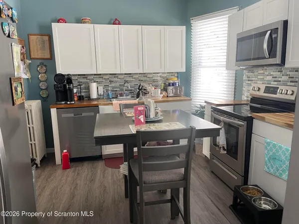 a kitchen with a stove a sink and a microwave