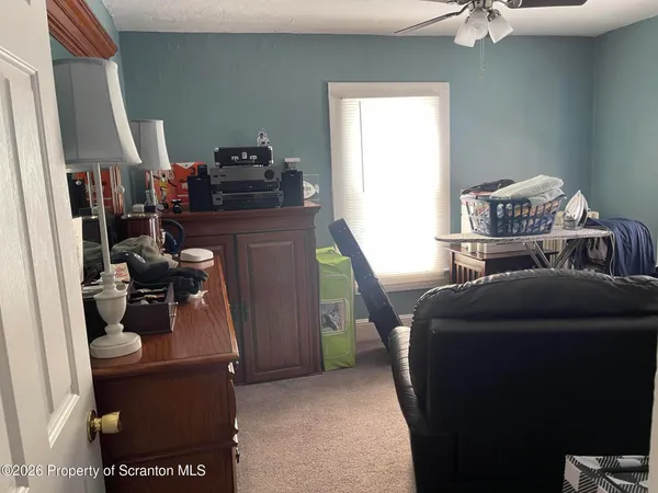 a bedroom with a bed and a mirror