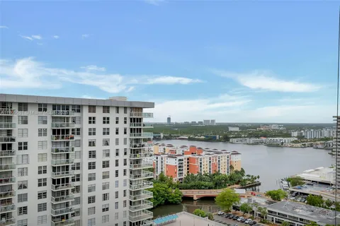 a view of a lake with a city skyline in the background