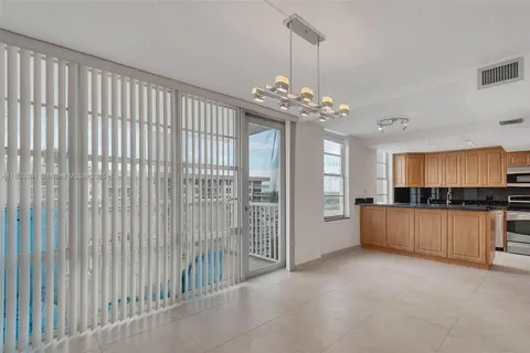 a view of a kitchen with a sink and dishwasher with wooden floor
