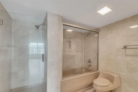 a bathroom with a toilet a sink and shower