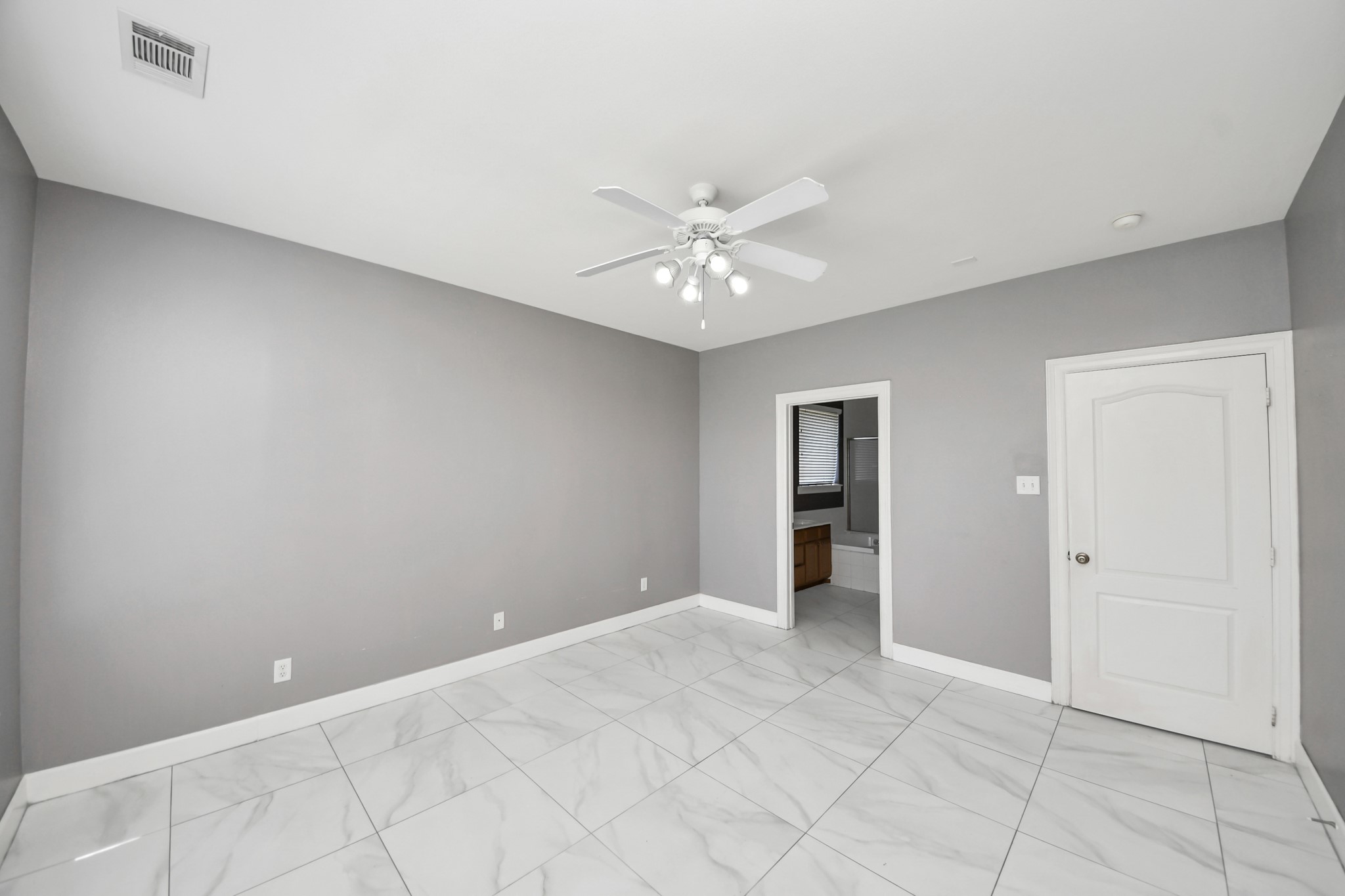 4610 Plum Forest Road Houston, TX 77084 - Photo 12 of 41 Again, no carpet throughout the home. Looking from the primary bedroom into the primary bath.