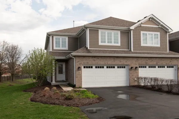 a front view of a house with a yard and garage