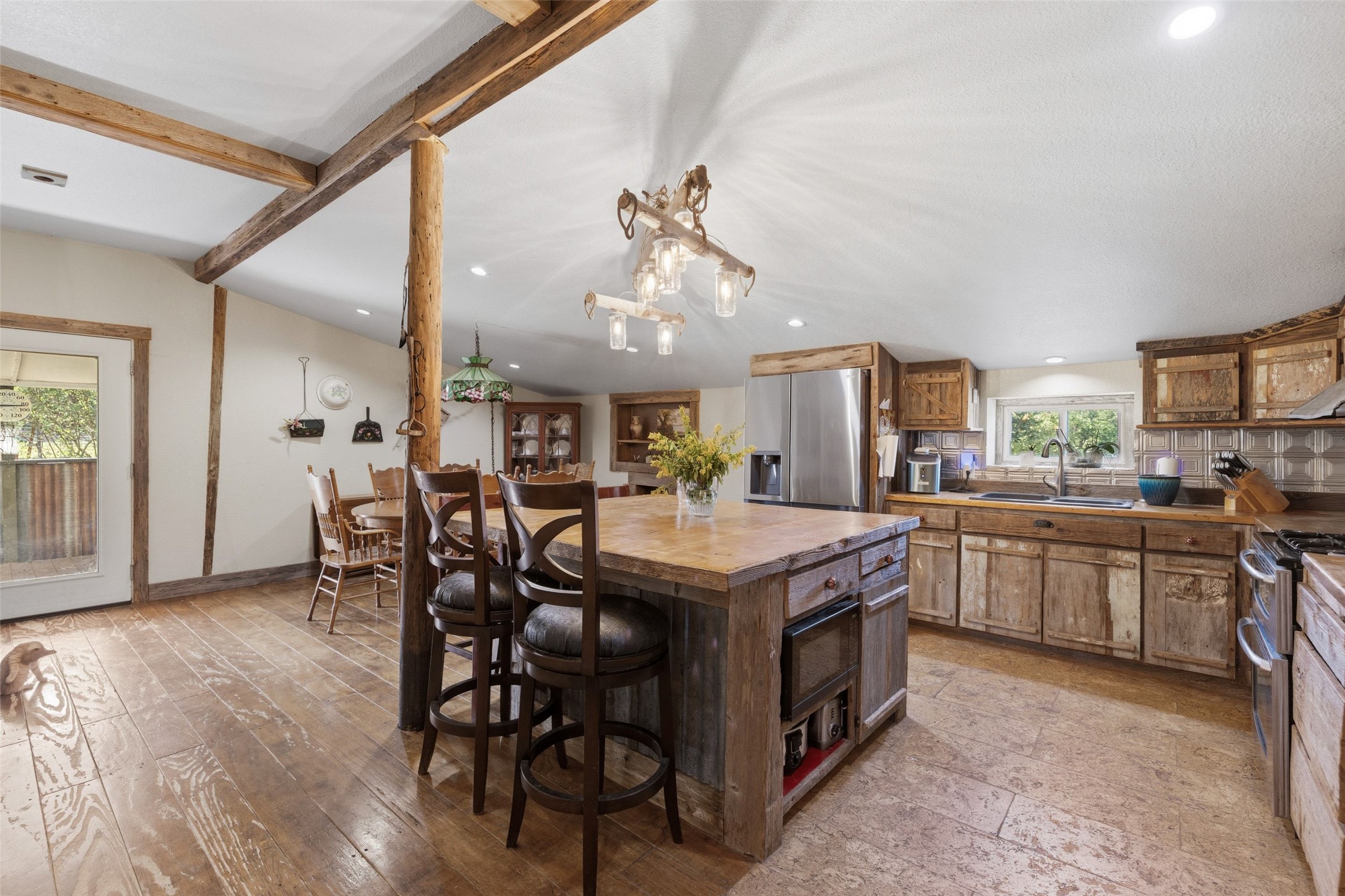 3764 Ranch Road 1623 Blanco, TX 78606 - Photo 12 of 36 Rustic wooden beams and a central island highlight this country-style kitchen.