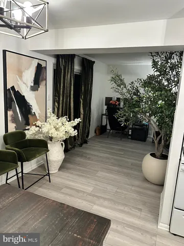 a living room with furniture and flowers