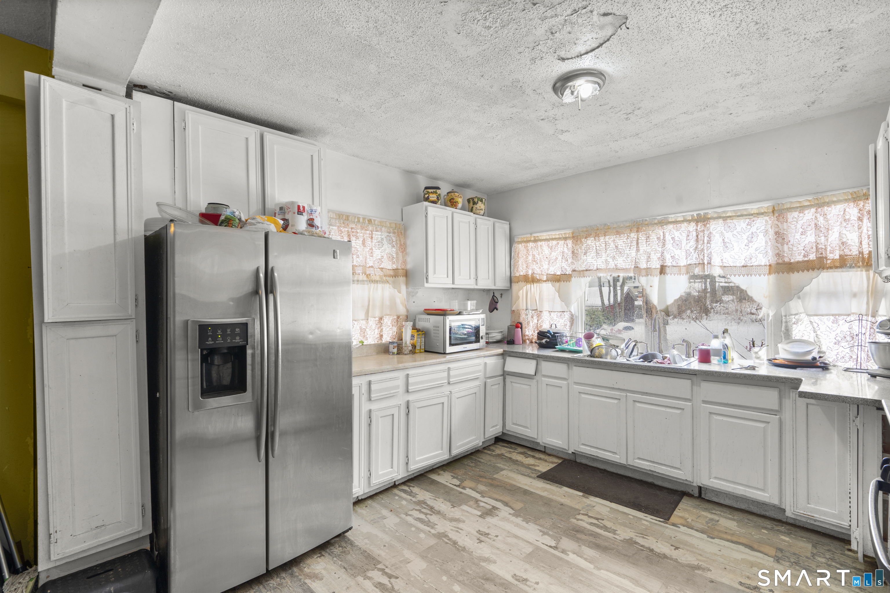 185 Bunker Hill Avenue Waterbury, CT 06708 - Photo 11 of 40 a kitchen with stainless steel appliances a refrigerator sink and cabinets