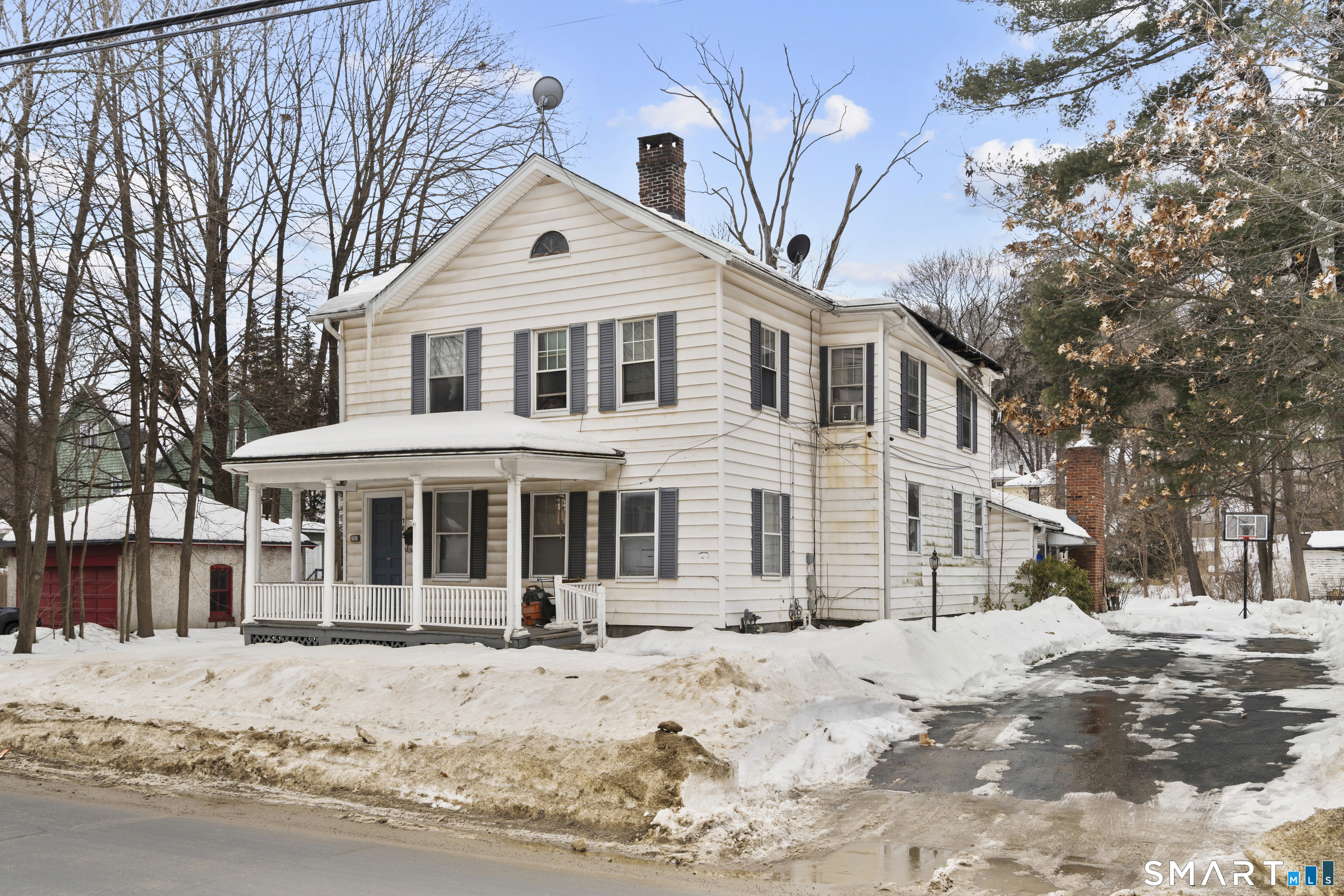 185 Bunker Hill Avenue Waterbury, CT 06708 - Photo 2 of 40 a front view of a house with a yard covered in snow