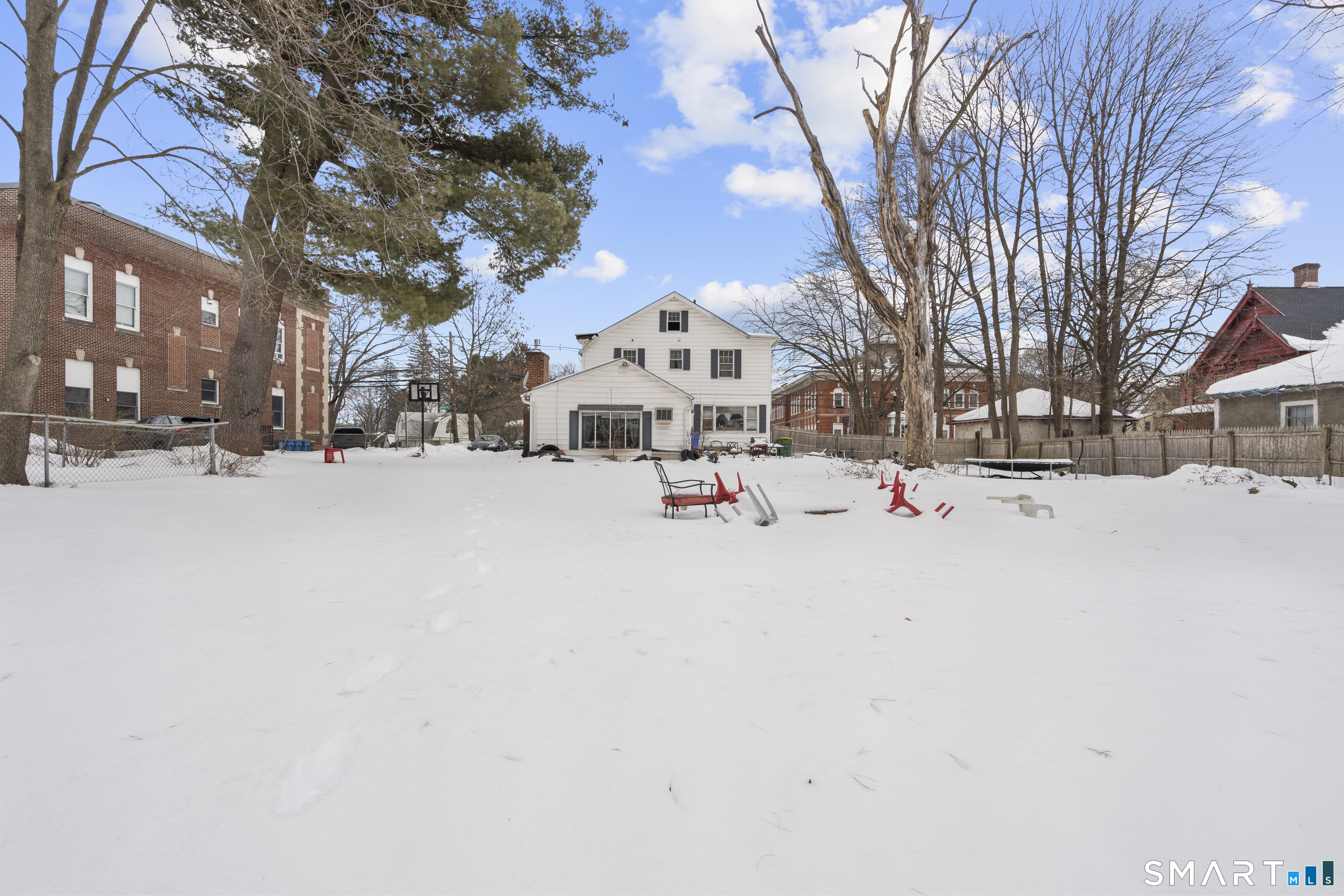185 Bunker Hill Avenue Waterbury, CT 06708 - Photo 37 of 40 a white house that has a tree in front of it