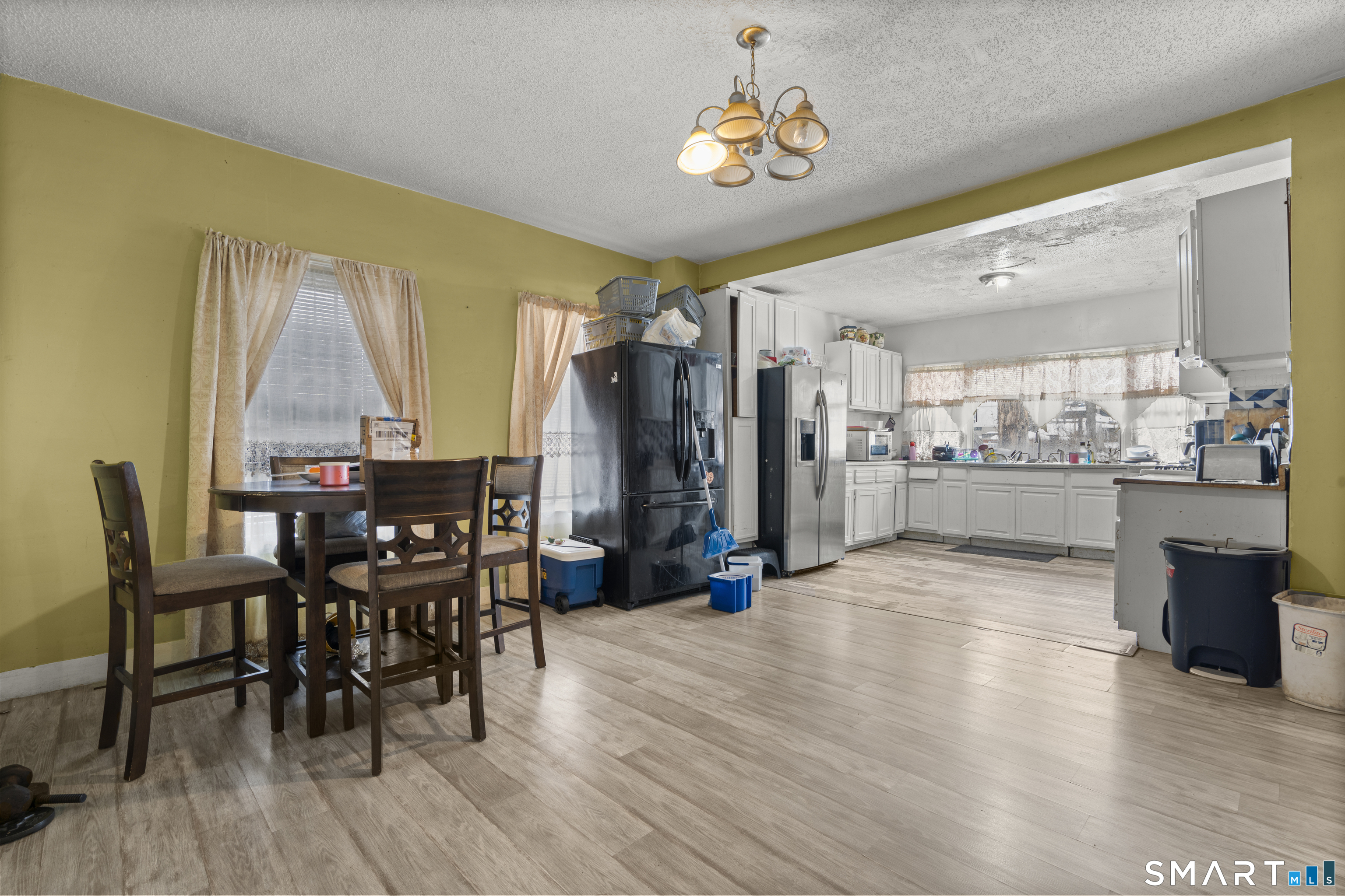 185 Bunker Hill Avenue Waterbury, CT 06708 - Photo 9 of 40 a view of a dining room with furniture window and wooden floor