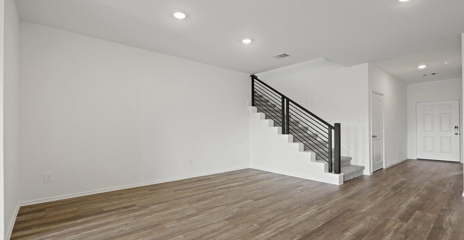 31722 Melkridge Road Fulshear, TX 77441 - Photo 11 of 20 a view of entryway and hall with wooden floor