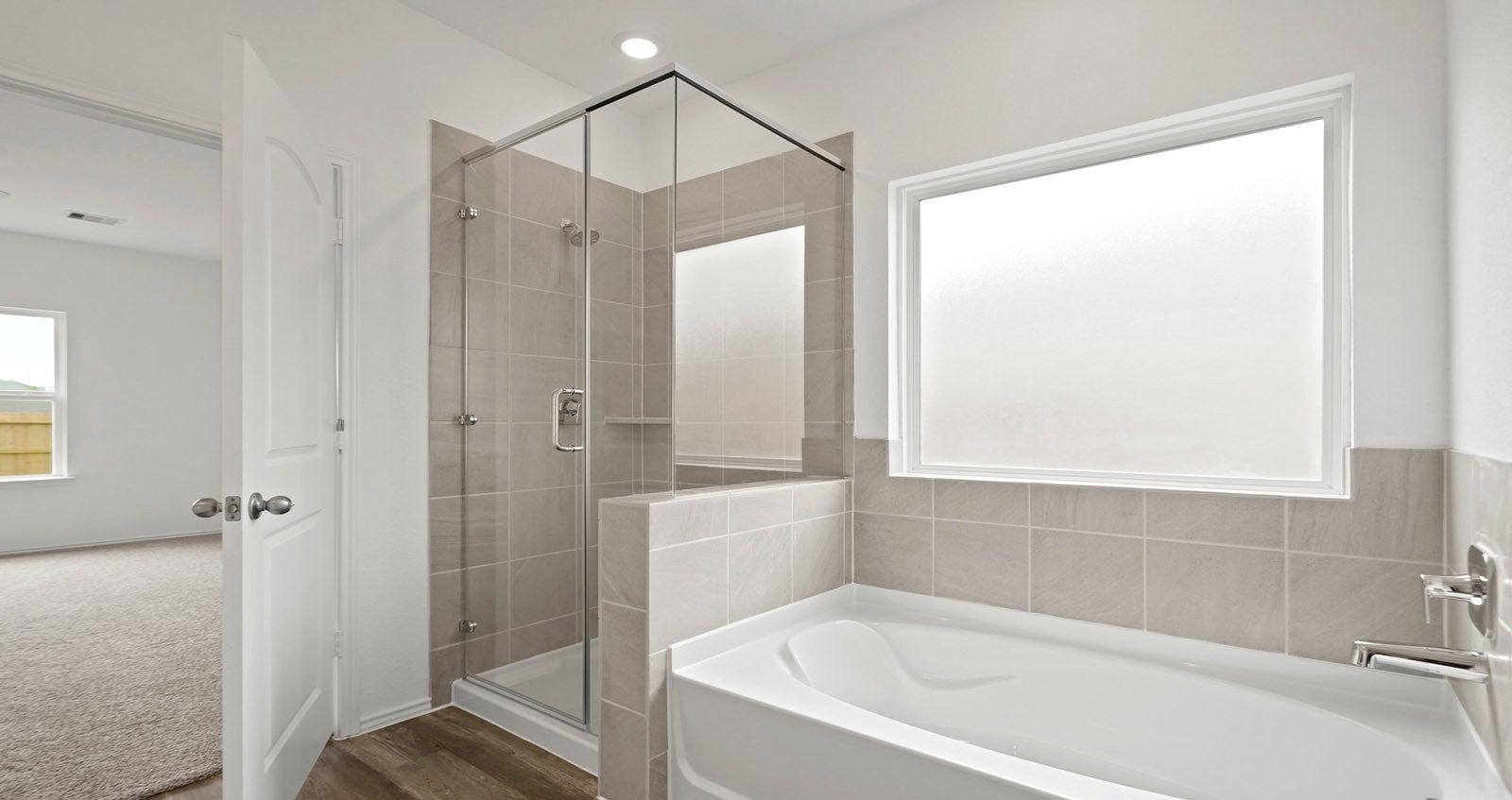 31722 Melkridge Road Fulshear, TX 77441 - Photo 14 of 20 a bathroom with a bathtub and a shower