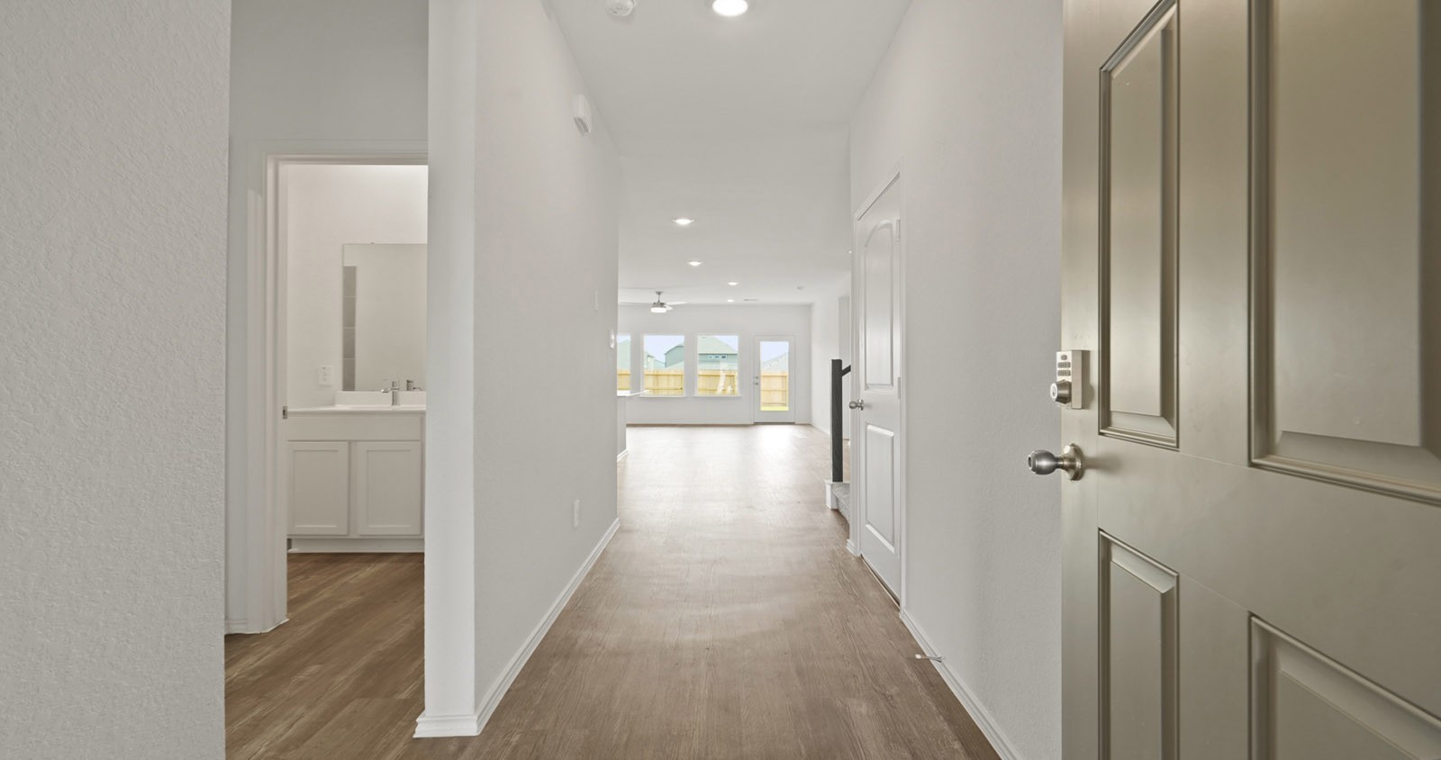 31722 Melkridge Road Fulshear, TX 77441 - Photo 2 of 20 a view of a hallway with wooden floor