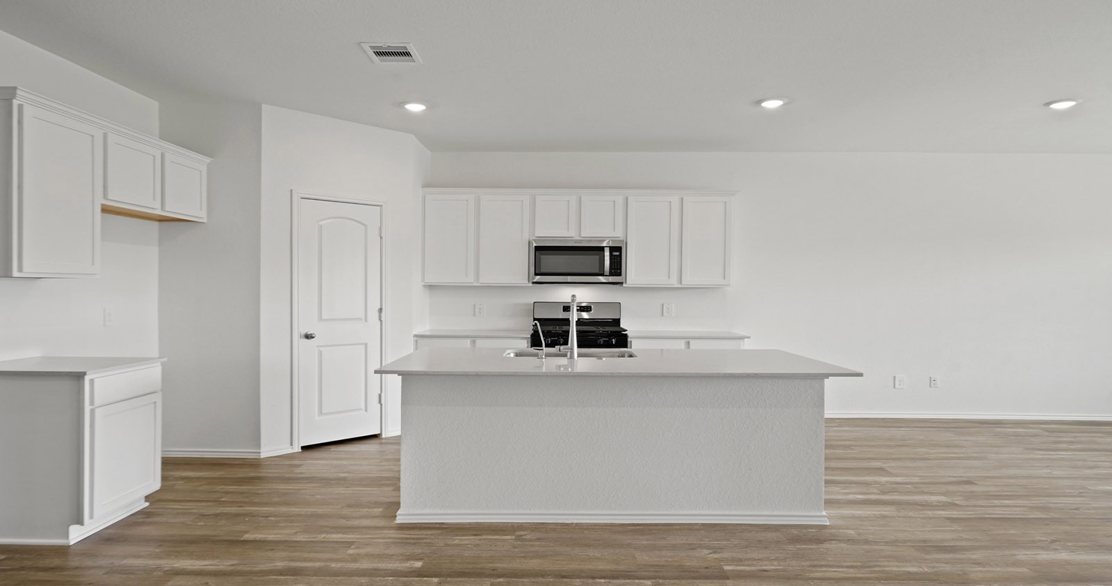 31722 Melkridge Road Fulshear, TX 77441 - Photo 6 of 20 a view of a kitchen with microwave and cabinets