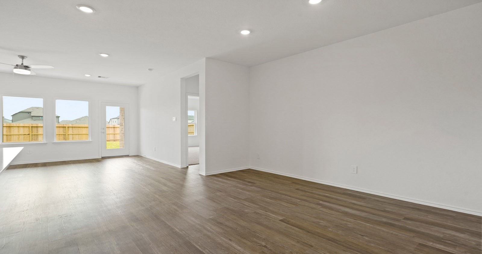 31722 Melkridge Road Fulshear, TX 77441 - Photo 9 of 20 a view of an empty room with a window and wooden floor