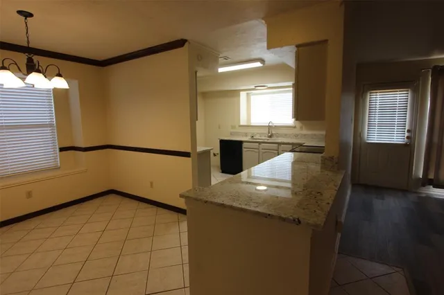 a kitchen with stainless steel appliances granite countertop a sink a stove top oven a counter space and cabinets