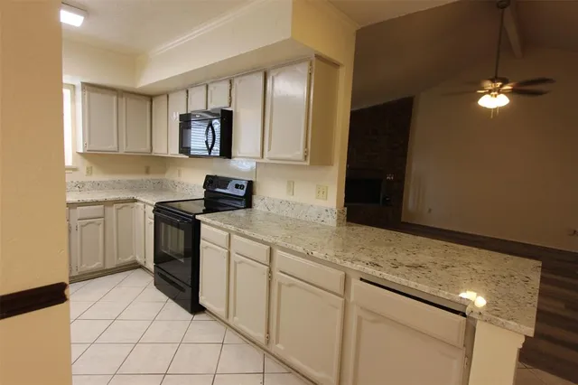 a kitchen with cabinets and appliances