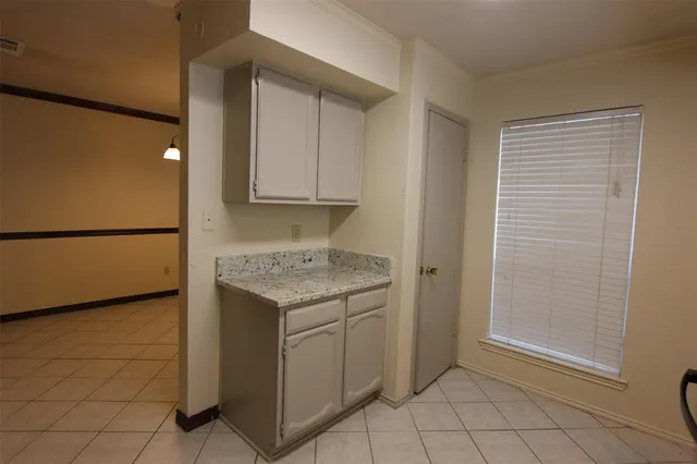 a utility room with cabinets washer and dryer