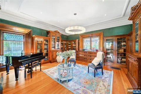 a spacious bedroom with a large bed and a chandelier