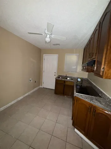 a kitchen with a sink a stove and cabinets