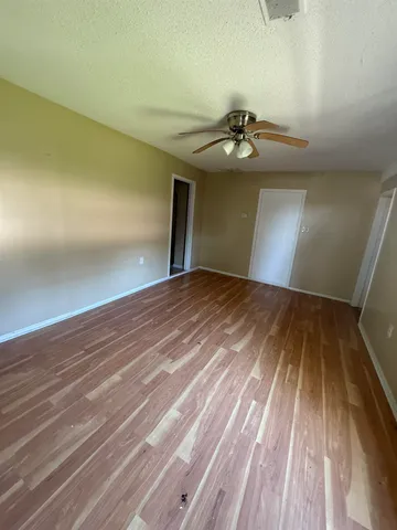a view of a room with wooden floor