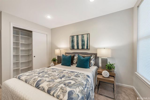 a bedroom with a bed and a potted plant