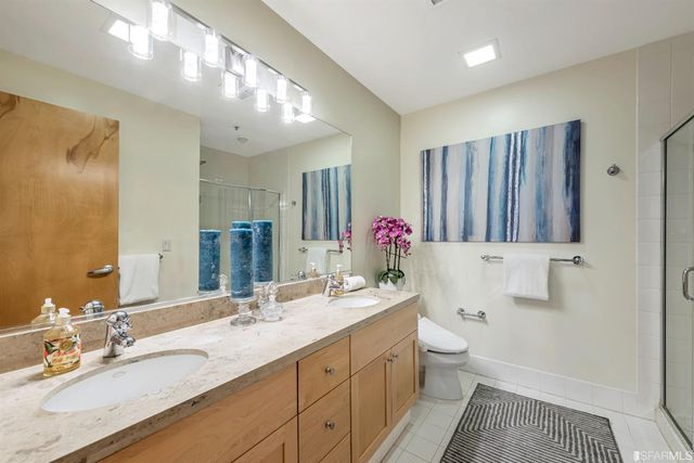 a bathroom with a sink a toilet and shower