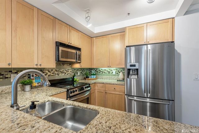 a kitchen with a sink stove and microwave