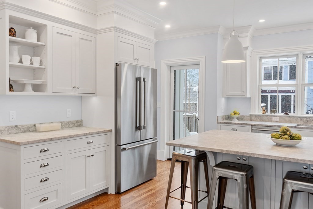 46 Hubbard Street Concord, MA 01742 - Photo 5 of 24 a kitchen with granite countertop a sink appliances cabinets and furniture