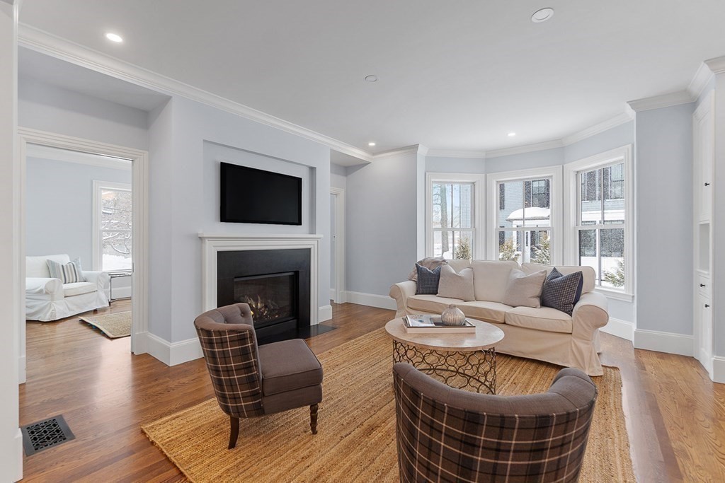 46 Hubbard Street Concord, MA 01742 - Photo 8 of 24 a living room with furniture a fireplace and a flat screen tv